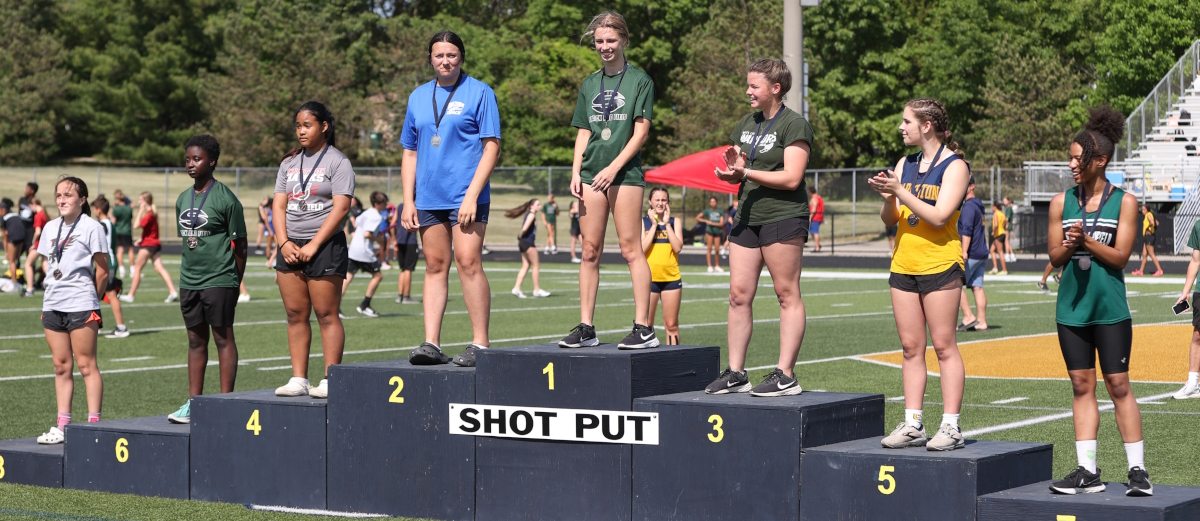 Girl Shot Put standing on award Podium